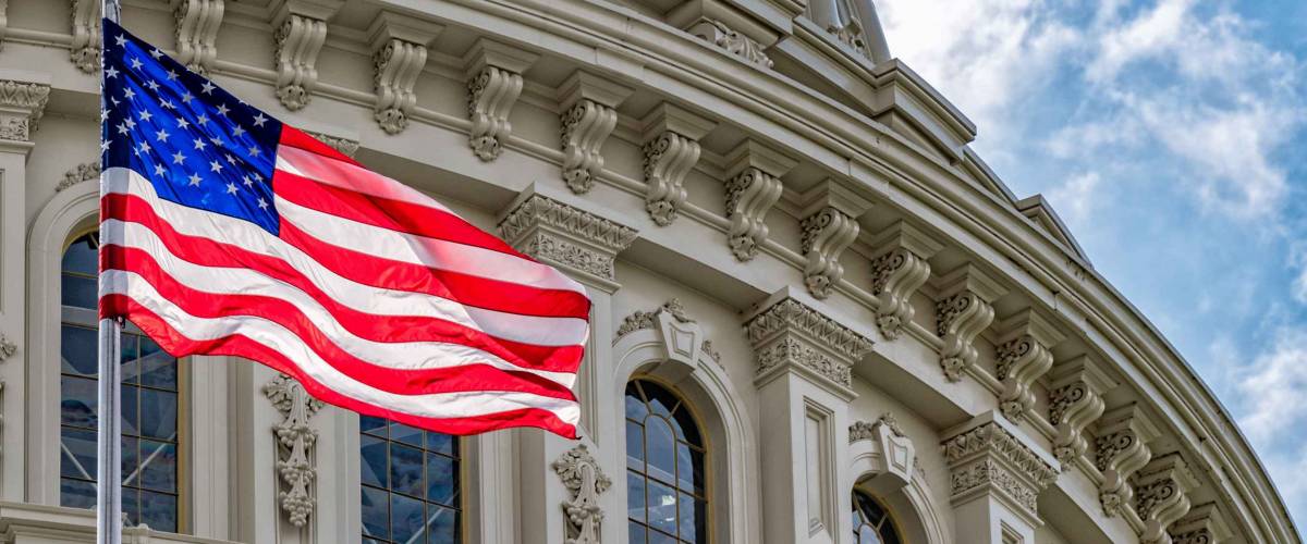 Washington DC Capitol dome detail with waving american flag