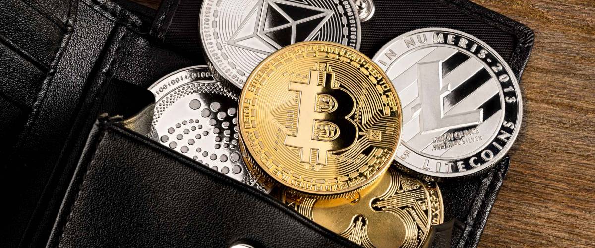 crypto currency coin in leather wallet on wide wood wooden background bitcoin ethereum litecoin iota ripple