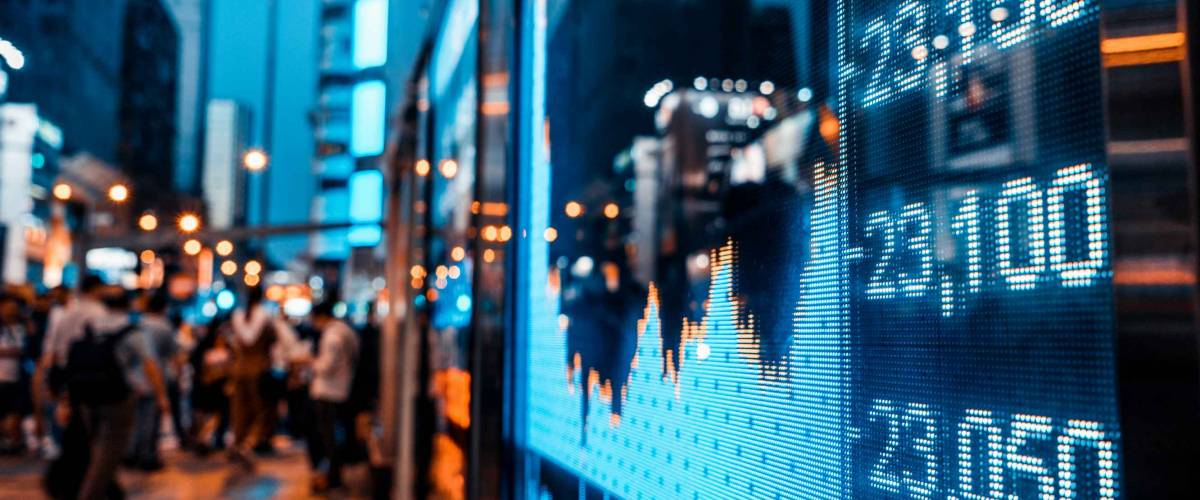 Display of Stock market quotes with city scene reflect on glass