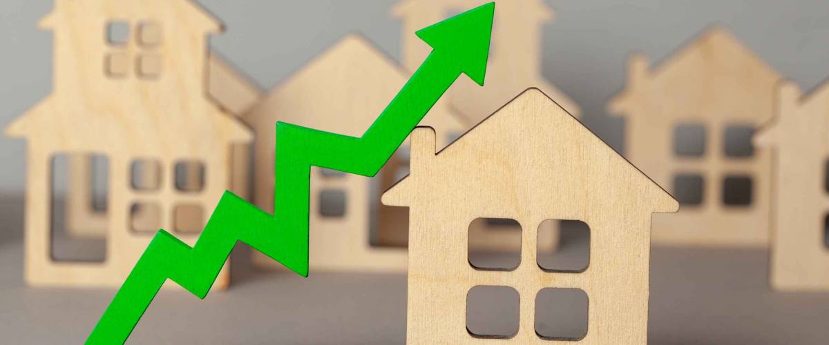 Up arrow and many houses. Growth in real estate prices market. Buying and selling house.