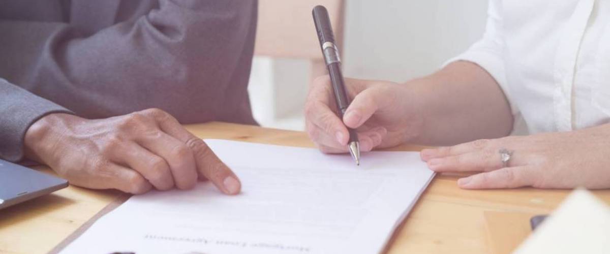 woman's hand hold ballpoint pen writing on agreement paper sheet, fill in document template, applying for mortgage loan