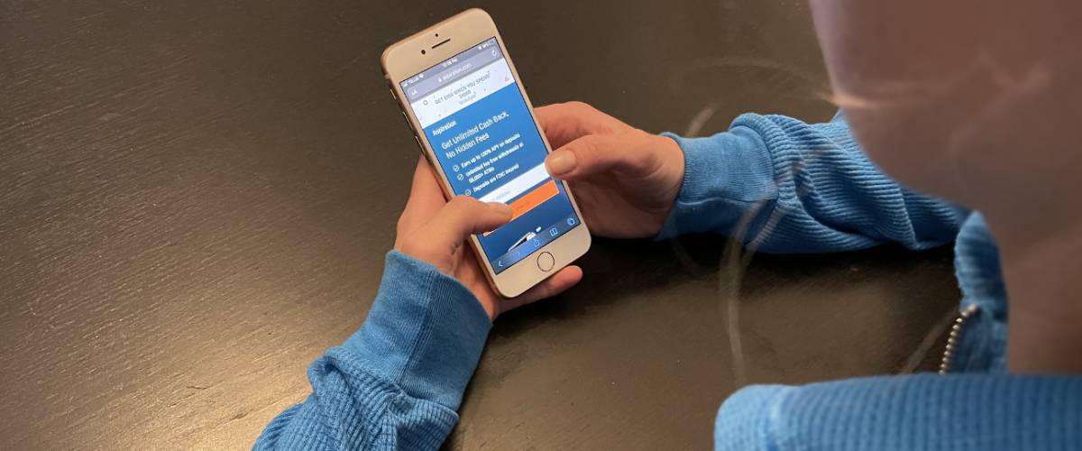 Woman signing up for Aspiration on her phone