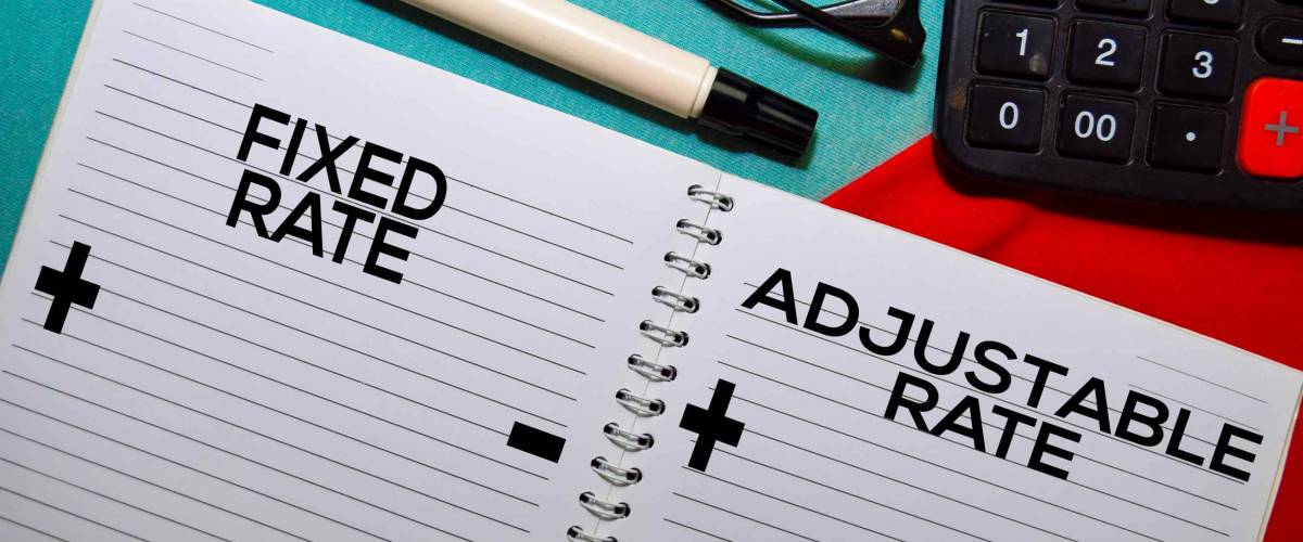 Fixed Rate and Adjustable Rate text on a book isolated on office desk.