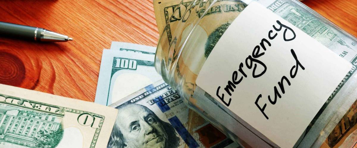 Emergency fund in the glass jar with cash.