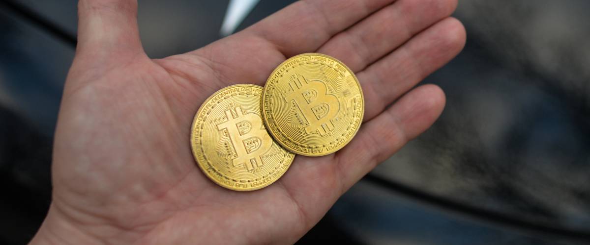 Man holding bitcoin in his hand, open palm