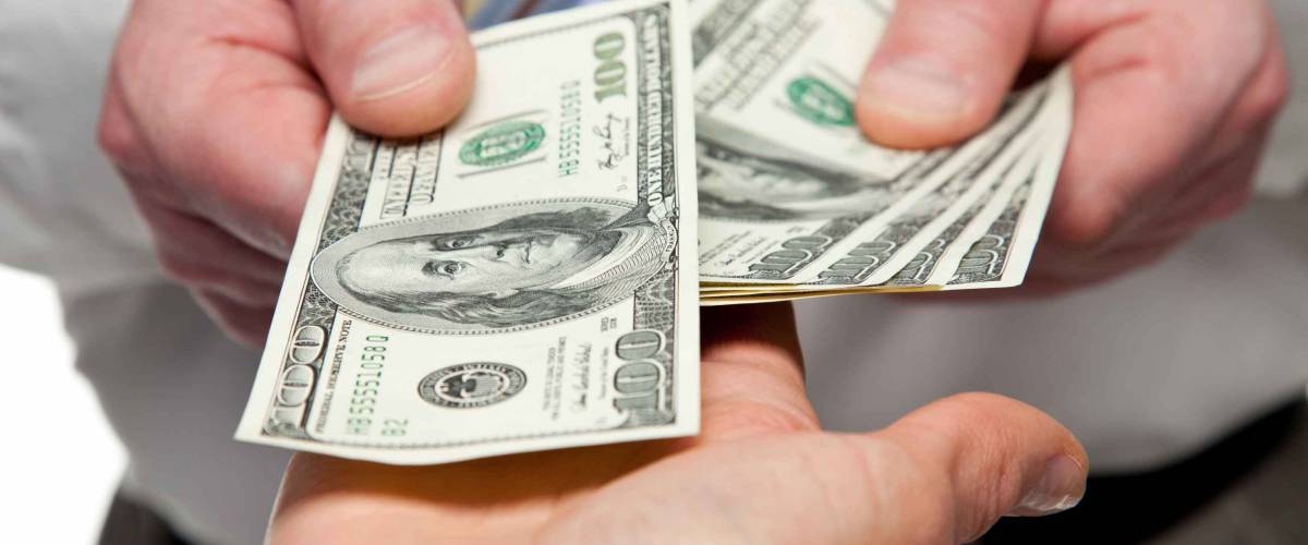 Hands exchanging money - closeup shot