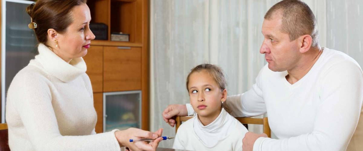 Sad family with documents at table in home