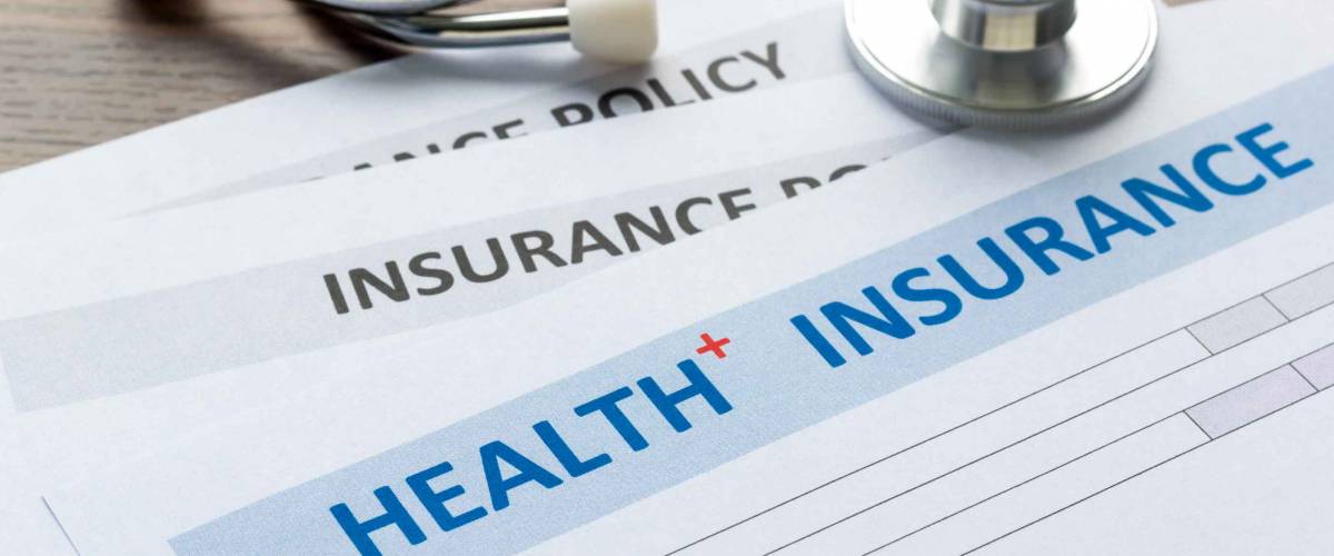 Health insurance form with stethoscope in top view