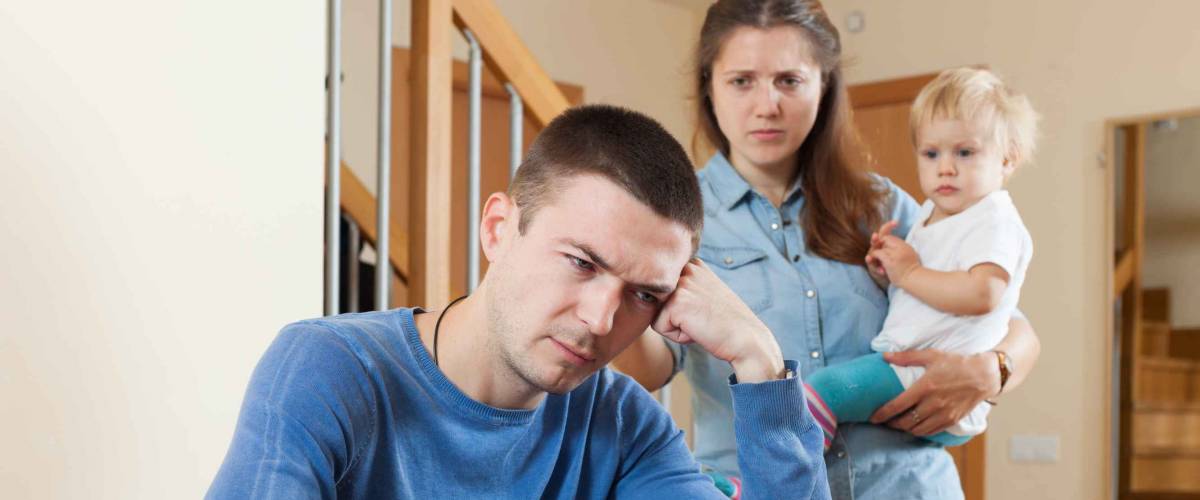 Family of three with baby having quarrel at home
