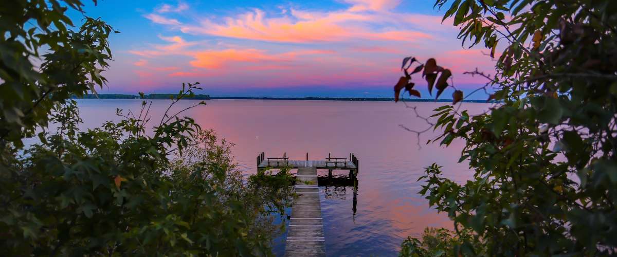 Lake and dock at sunset beautiful colours in the sky
