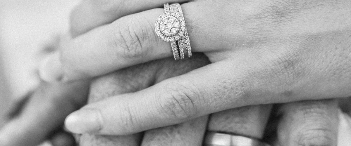 Marriage rings and hands holding