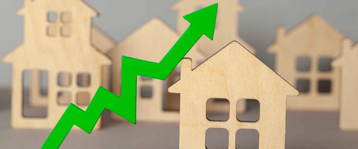 Up arrow and many houses. Growth in real estate prices market. Buying and selling house.