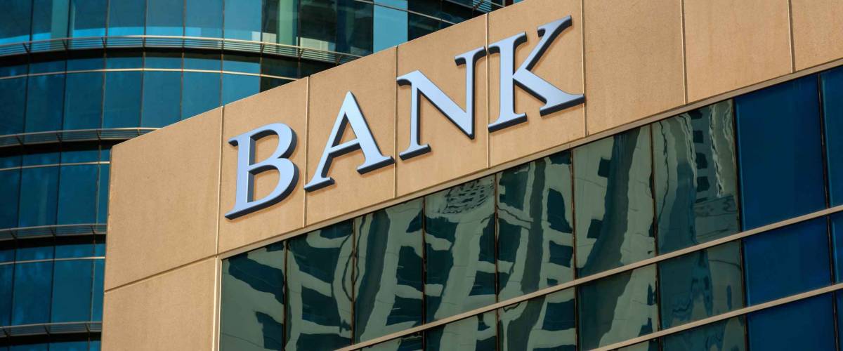 Bank sign on glass wall of business center