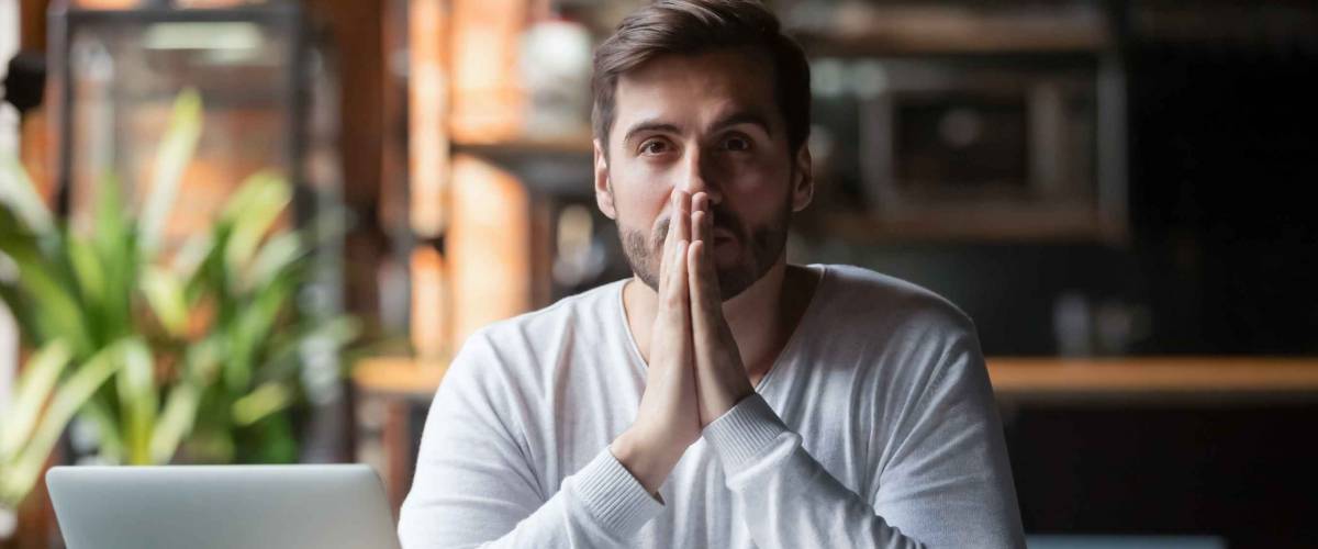 Thoughtful doubtful businessman in tension wondering if student loan refinancing is the right move.