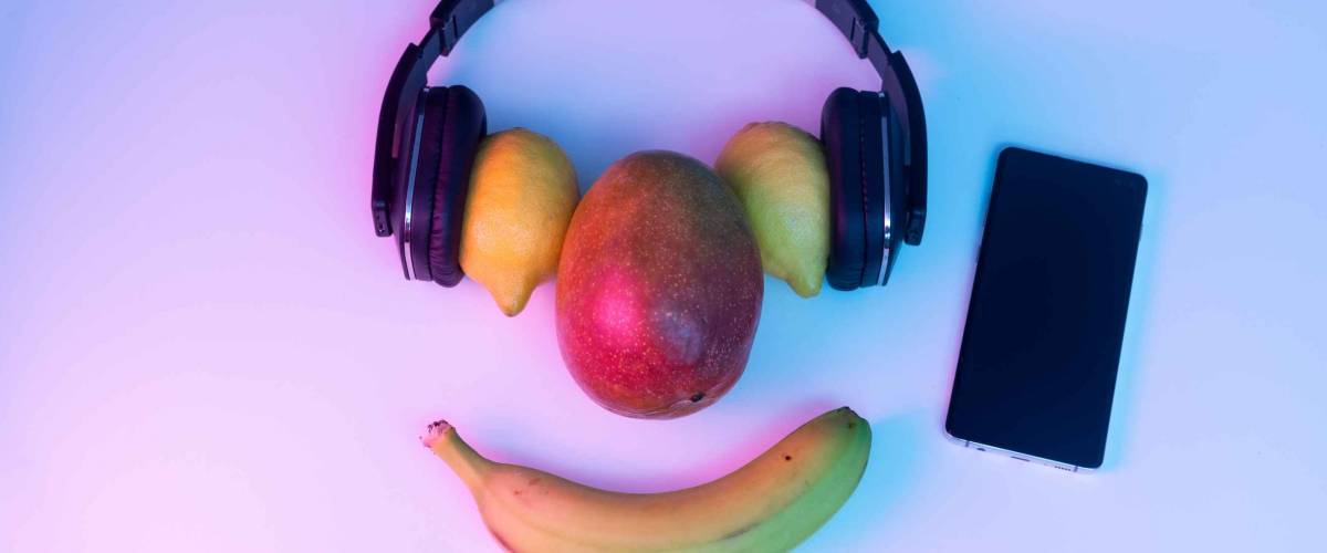 Fruit and vegetables listening to music with phone and disco lights.
