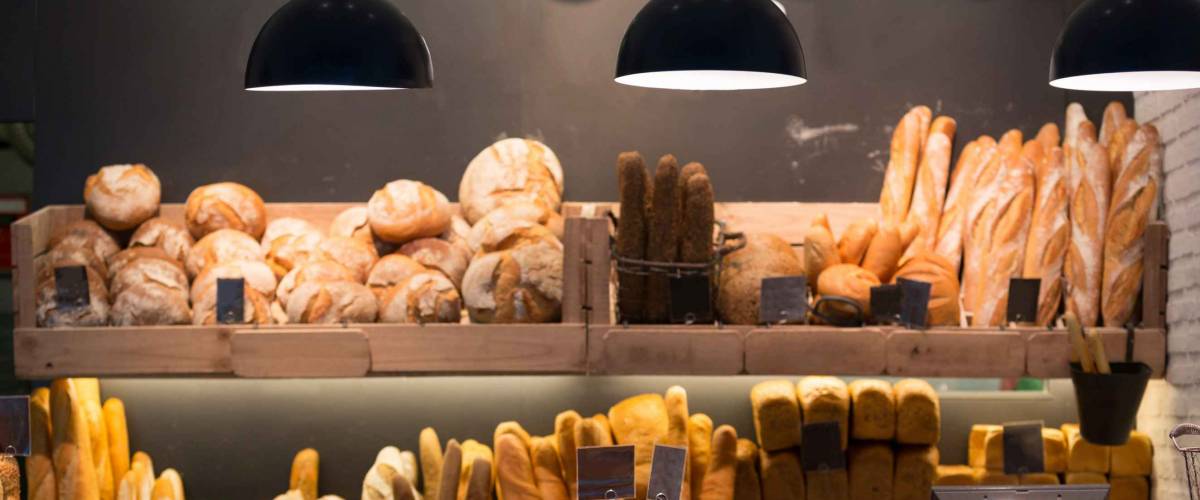 Modern bakery with different kinds of bread, cakes and buns
