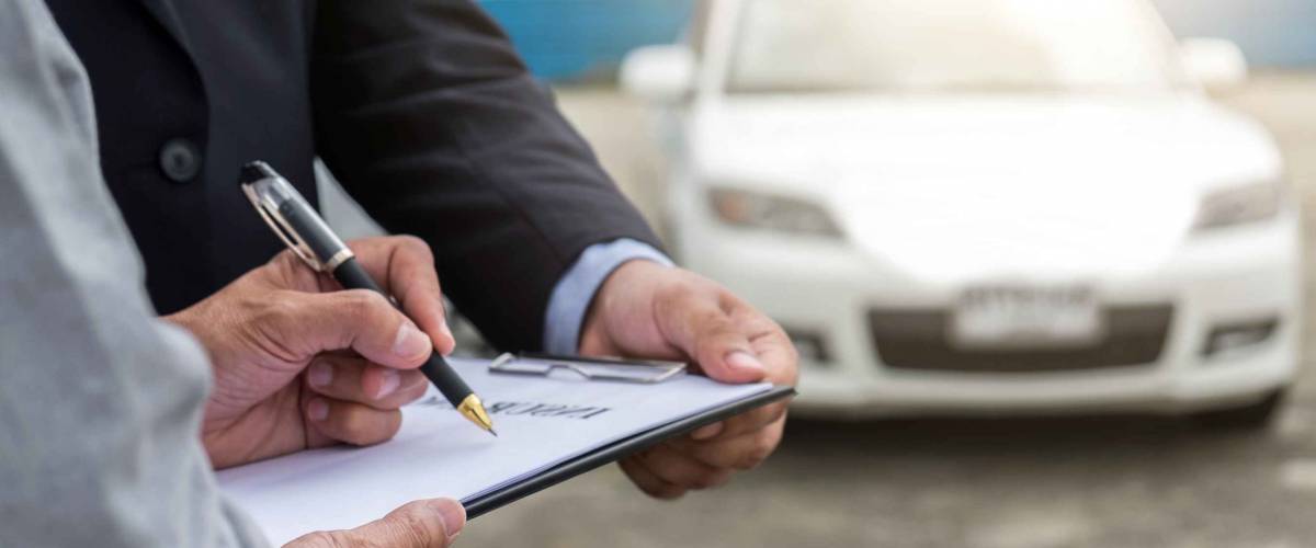 Man holds pen and clipboard while other man holds it steady