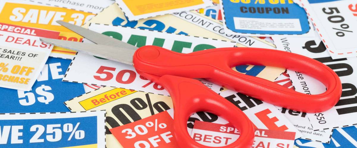 Saving discount coupon voucher with scissor, coupons are mock-up