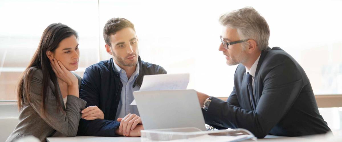 Young couple meeting financial advisor for home investment