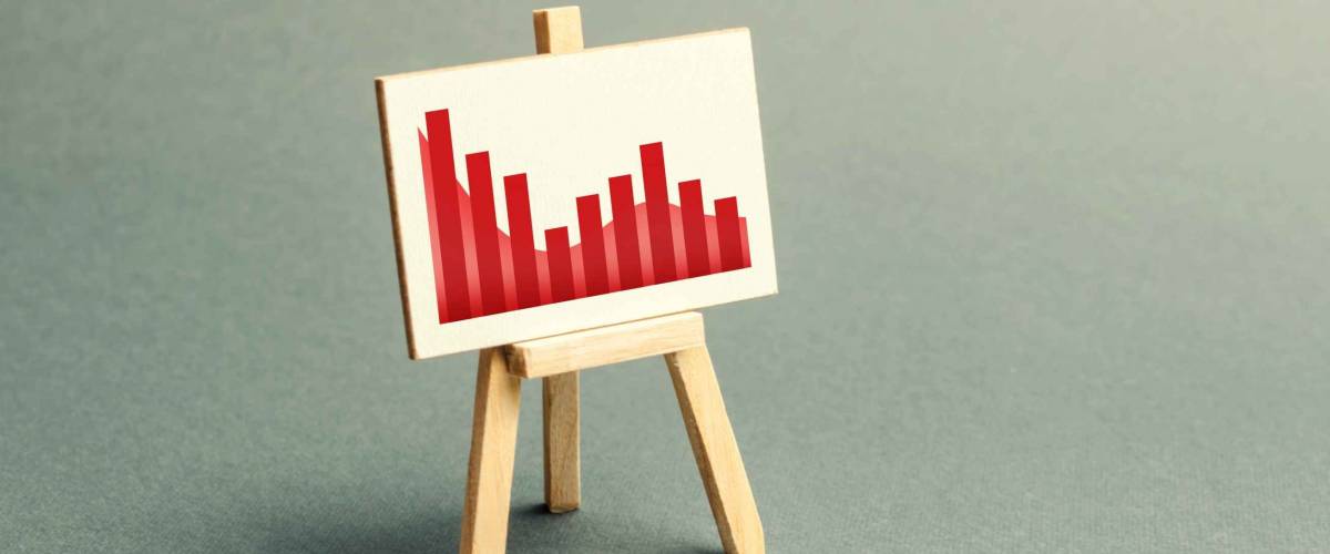 A stand with a canvas and a red downtrending trend.
