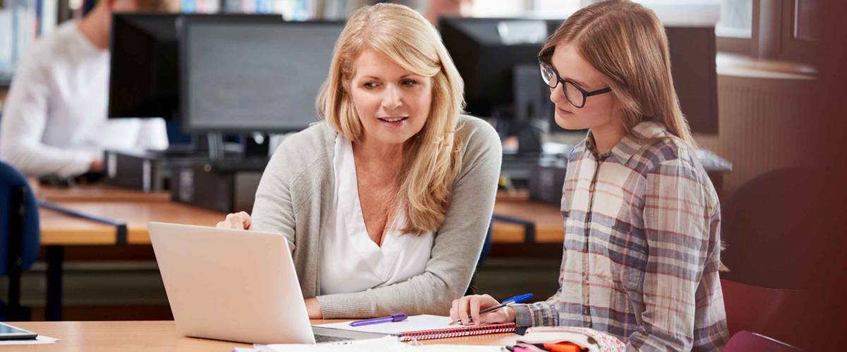 College Student Has Individual Tuition From Teacher In Library