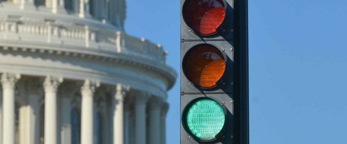 Green traffic light and U.S. Capitol Dome that symbolizes positive political decision - Washington D.C. United States of America