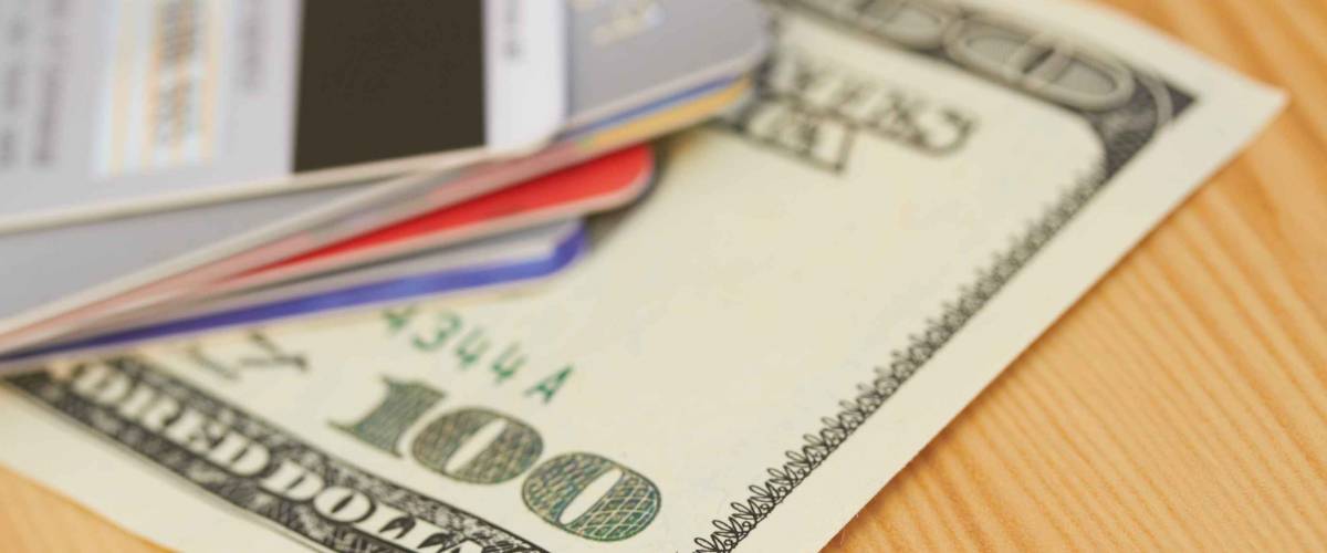 Credit card and 100 dollar close-up