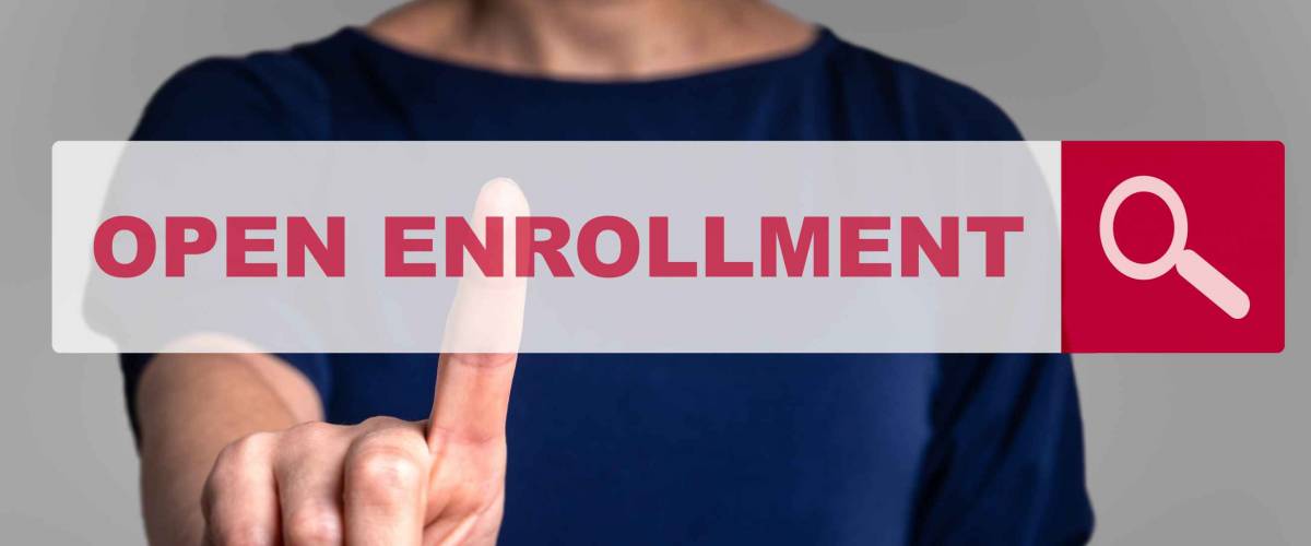 Person holding finger out, reaching it towards a search bar imposed over their body that says Open Enrollment