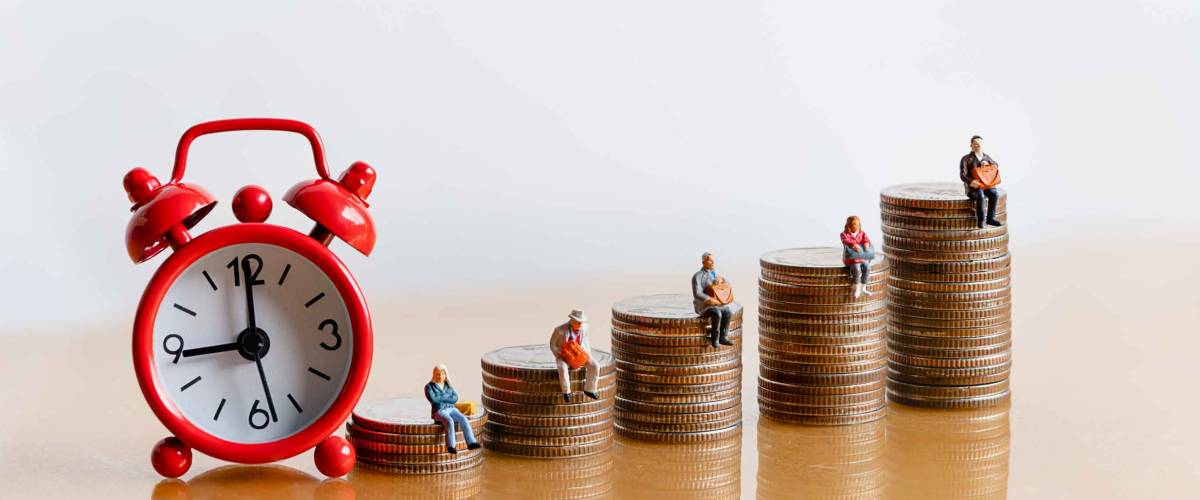 Miniature people: Red alarm clock and elderly people sitting on coins stack. Retirement planning. money saving and Investment. Time counting down for retirement and pension.