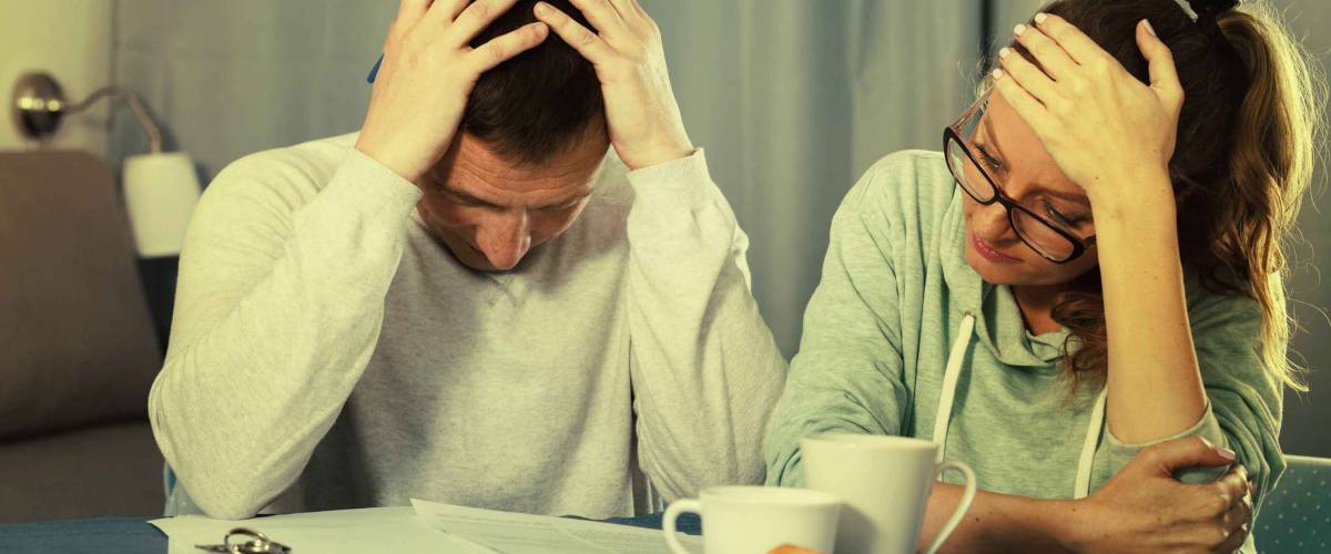 Middle-aged family having difficulties with paying utility bills and rent
