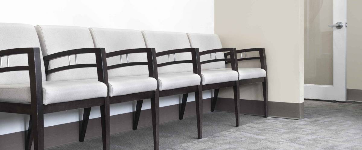 empty chairs in a doctors office waiting area