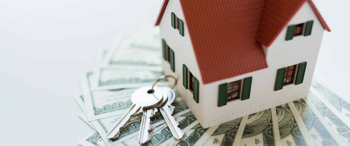 mortgage, investment, real estate and property concept - close up of home model, dollar money and house keys