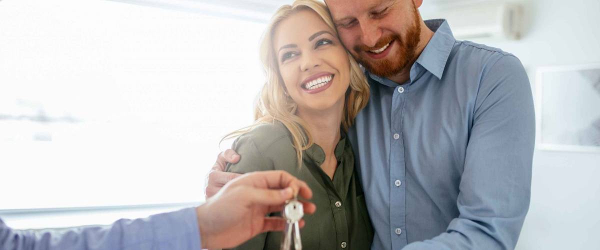 Happy couple moving in a new house.