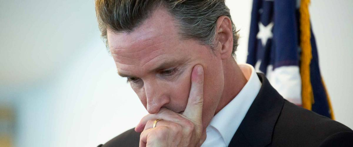 Sacramento, California / USA - May 31, 2020: California State Governor Gavin Newsom holds his head in though before a meeting.