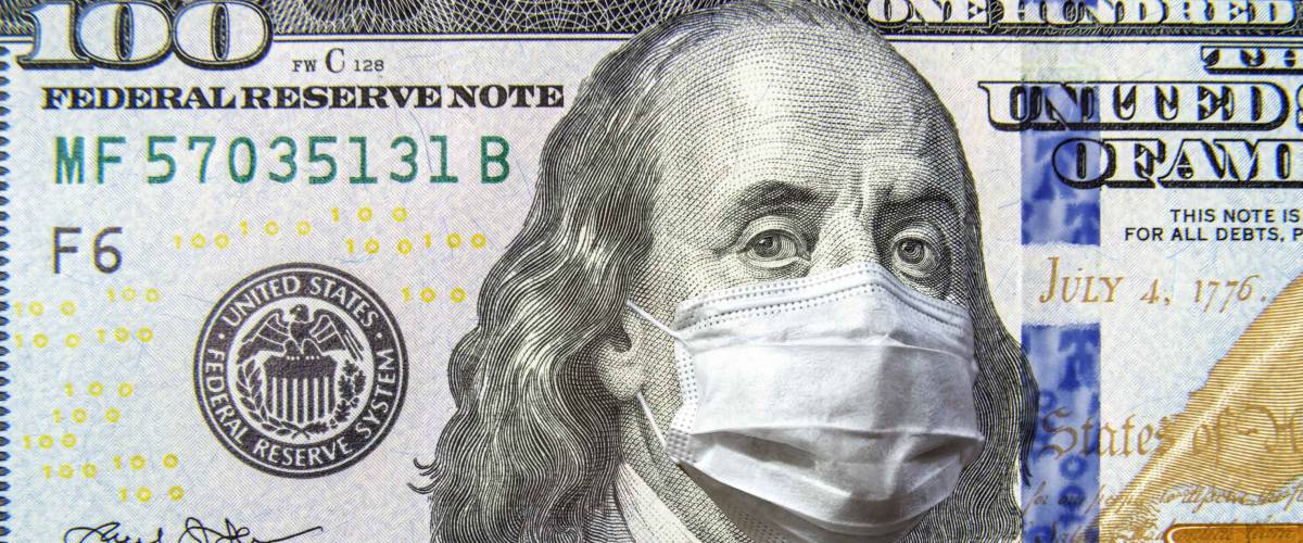 COVID-19 coronavirus in USA, 100 dollar money bill with face mask.