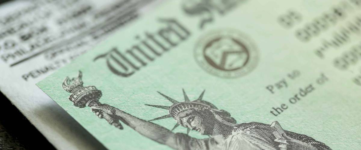 Extreme close-up of Federal coronavirus stimulus check provided to all Americans from the United States Treasury in 2020 and 2021, showing the statue of liberty.