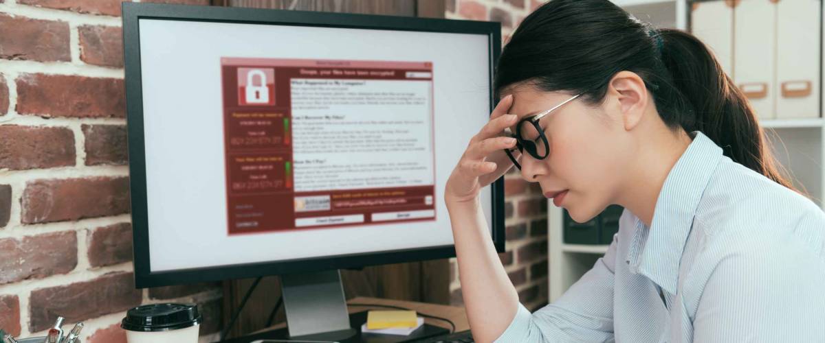 sadness company agent woman finding working computer getting blackmail virus attack thinking solution at office desk and feeling depression.