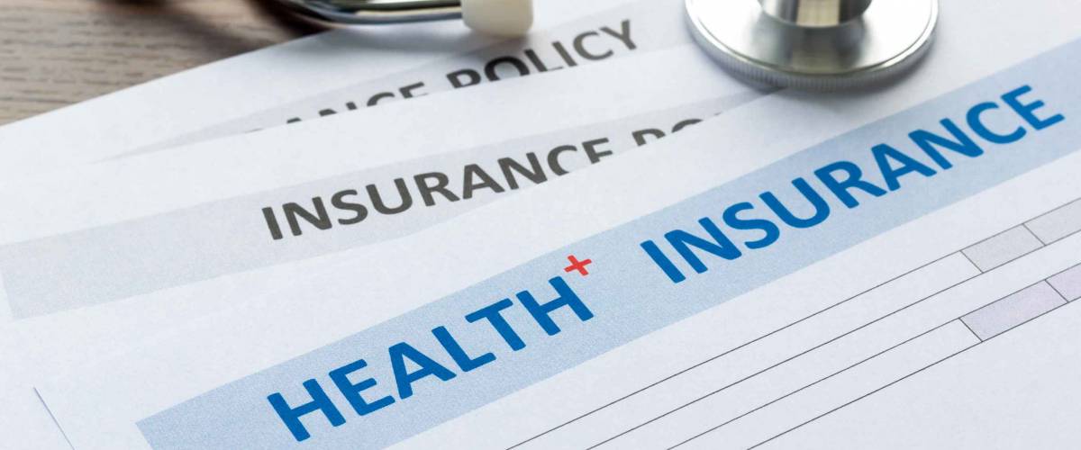 Health insurance form with stethoscope in top view