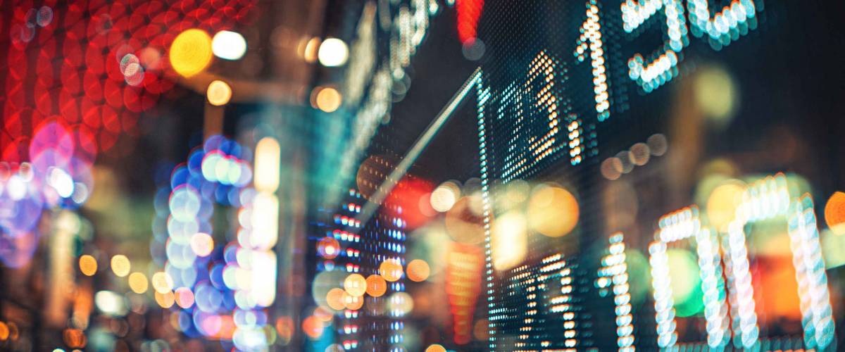 Display of Stock market quotes with city scene reflect on glass