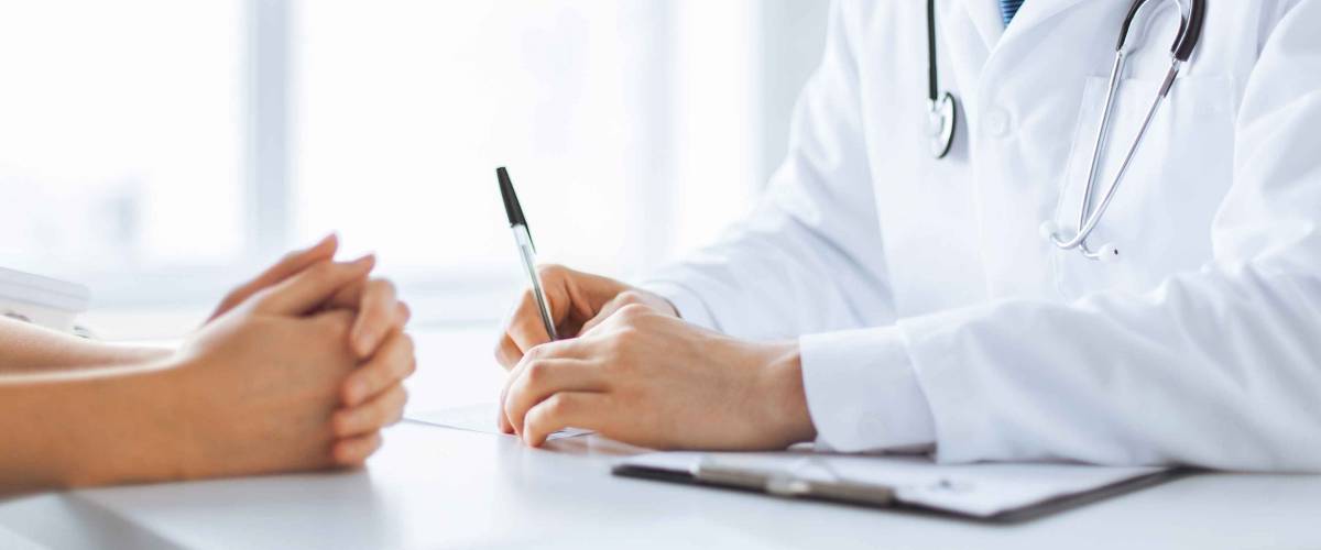 close up of patient and doctor taking notes