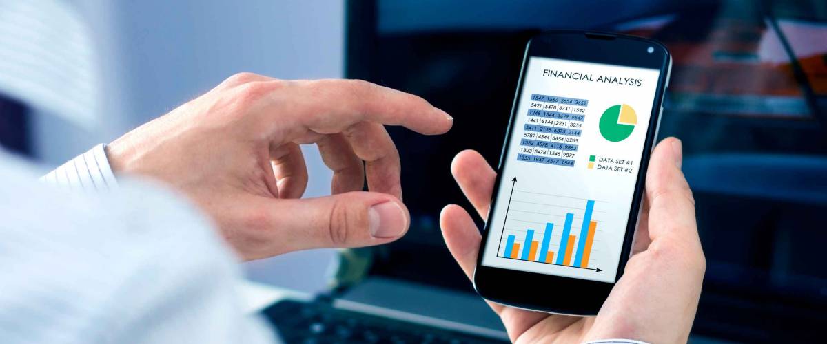 Businessman checks the financial analysis on smartphone