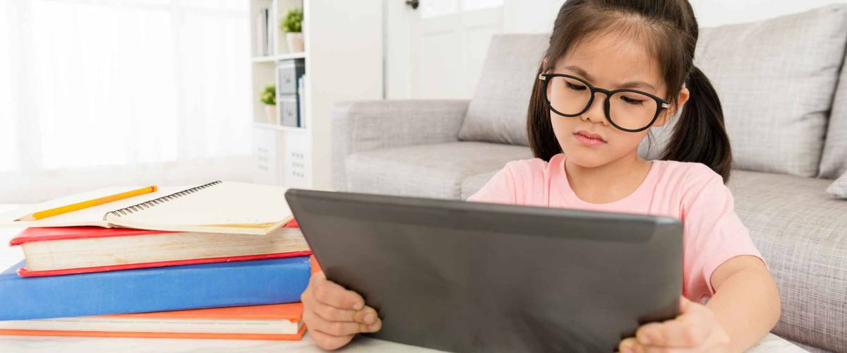 unhappy lovely girl student using mobile digital tablet looking online e-learning teaching video at home and feeling boring.