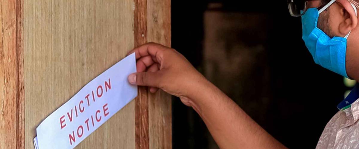 Asian man finds eviction notice on the door of the house
