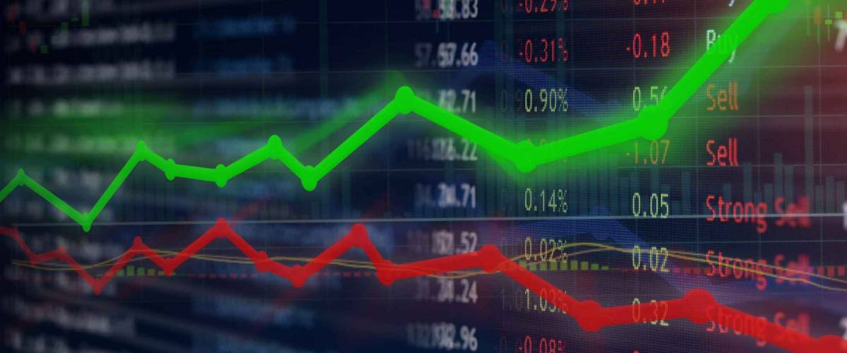Investing and stock market concept gain and profits with faded candlestick charts.