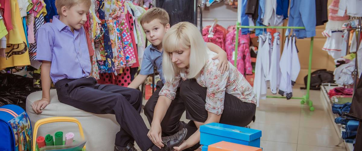 young beautiful woman with children in shop