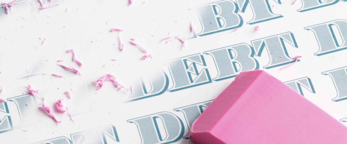 Pink eraser erasing multiple debts written in money font.