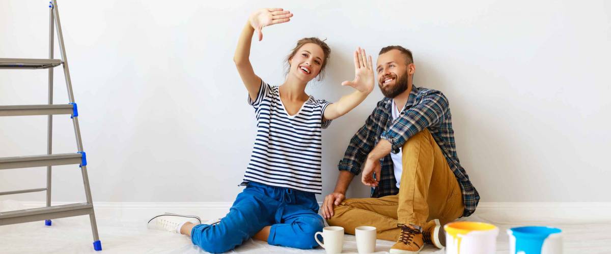 young happy family married couple dreams of renovating house and planning a design project