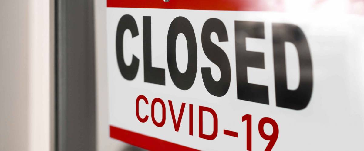 Closed businesses for COVID-19 pandemic outbreak, closure sign on retail store window banner background. Government shutdown of restaurants, shopping stores, non essential services.