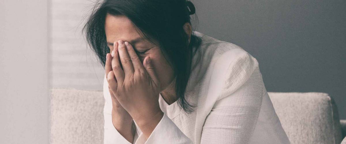 Coronavirus COVID-19 impact on retail businesses shut down causing unemployment financial distress. Depressed crying business woman stressed with headache.
