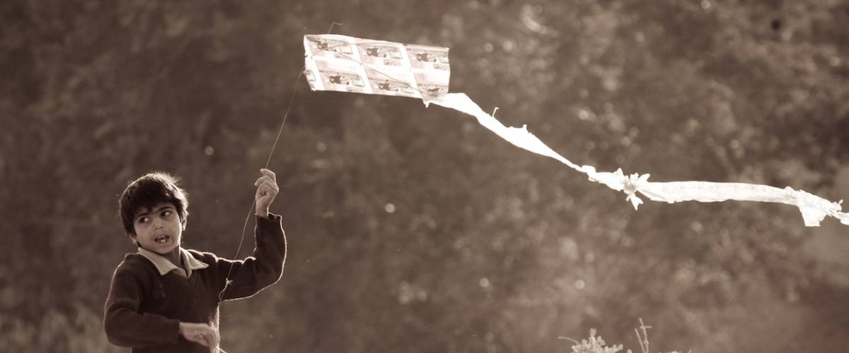 Young Indian boy flying a kite